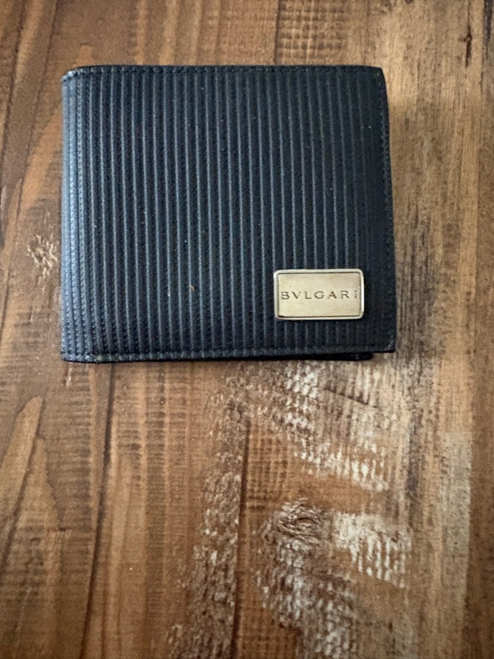 Bulgari Black Textured Bi-Fold Wallet with Gold Plaque